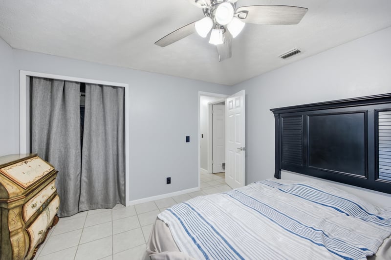 Bedroom with dark furniture and curtained closet at 417 Capricorn Ln, Orange Park, FL 32073