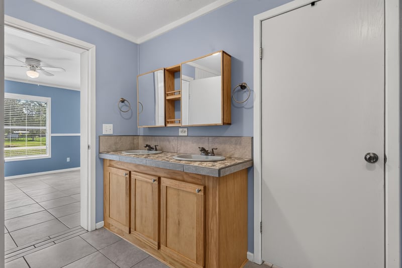 Bathroom vanity with wood cabinets at 2549 Snapdragon Ave, Middleburg, FL 32068