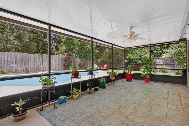 Screened lanai with pool and tile floor at 12810 Swamp Owl Ln