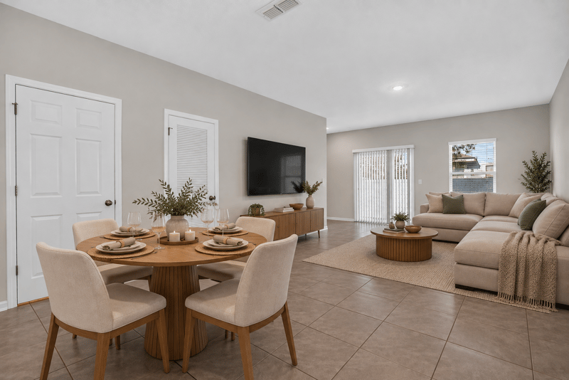 Open living and dining area with staged furniture at 4024 Bay Hawk Ct, Jacksonville, FL