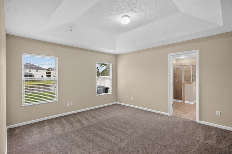 Carpeted bedroom with two windows at 469 Glendale Ln, Orange Park, FL