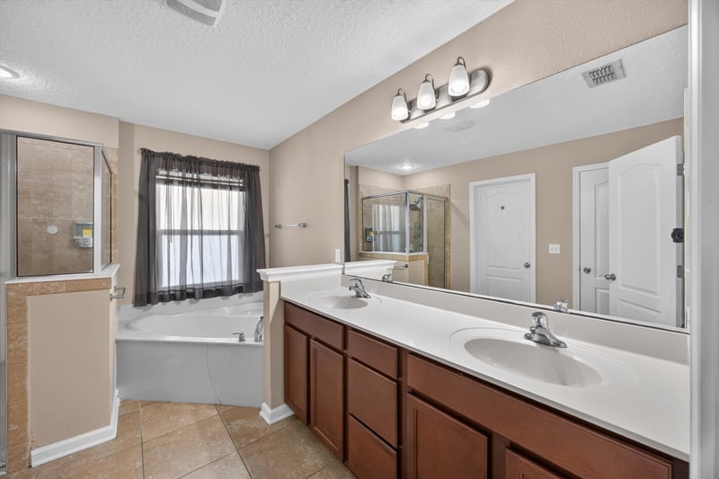 Bathroom with double vanity and soaking tub at 469 Glendale Ln, Orange Park, FL