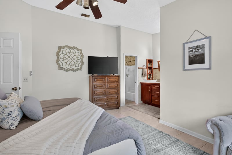 Bedroom with bed and wall-mounted TV at 13020 Medford Ln, Jacksonville, FL 32225