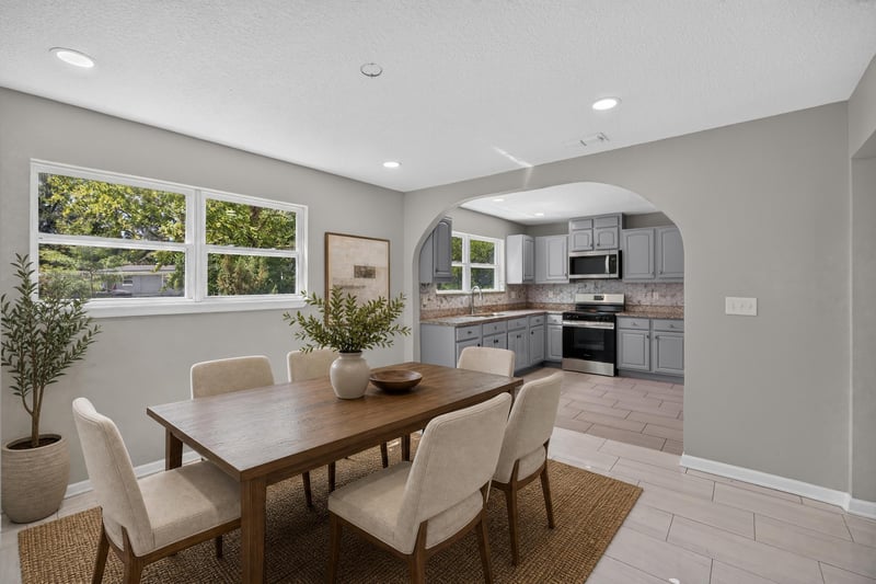 Virtually staged dining area with table and chairs at 7015 Miss Muffet Ln N, Jacksonville, FL 32210