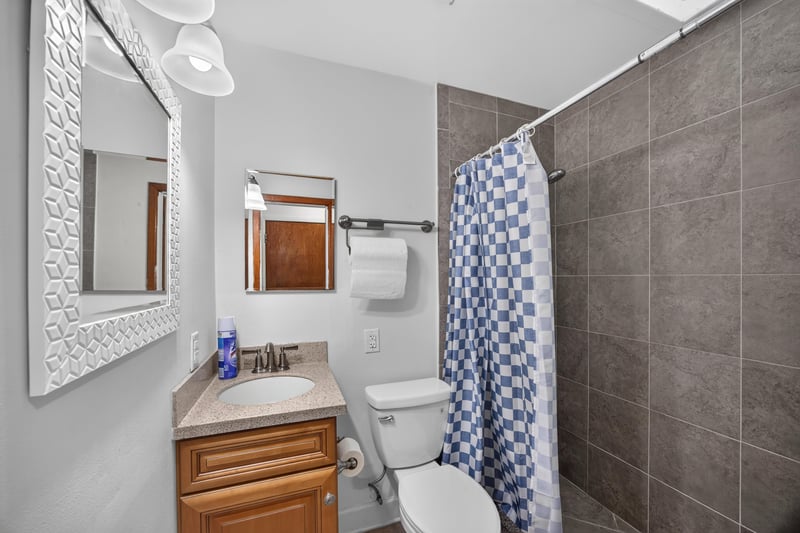 Bathroom with tub-shower combo and mirror at 1847 Grove Park Dr, Orange Park, FL