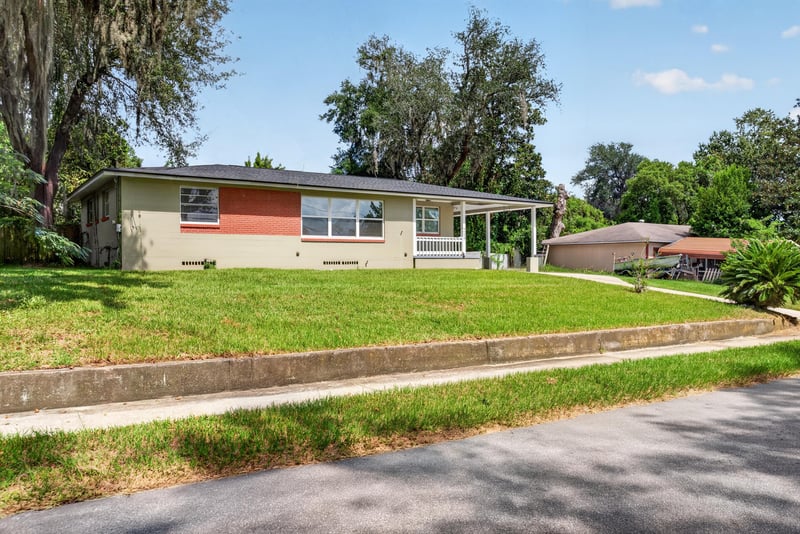 Front view of ranch home with two-tone exterior and curved walkway at 217 Baisden Rd, Jacksonville, FL 32218