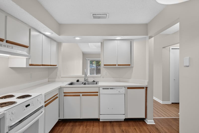 Kitchen with white cabinets at 8010 International Village Dr, Jacksonville, FL 32277