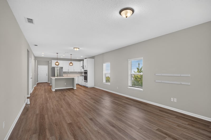 Open dining and kitchen area with wood floor at 75875 Saffron Ln, Yulee, FL 32097