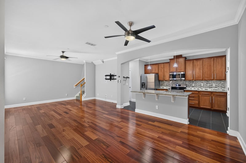 Open living area with ceiling fan and view to kitchen at 6217 Eclipse Cir, Jacksonville, FL 32258