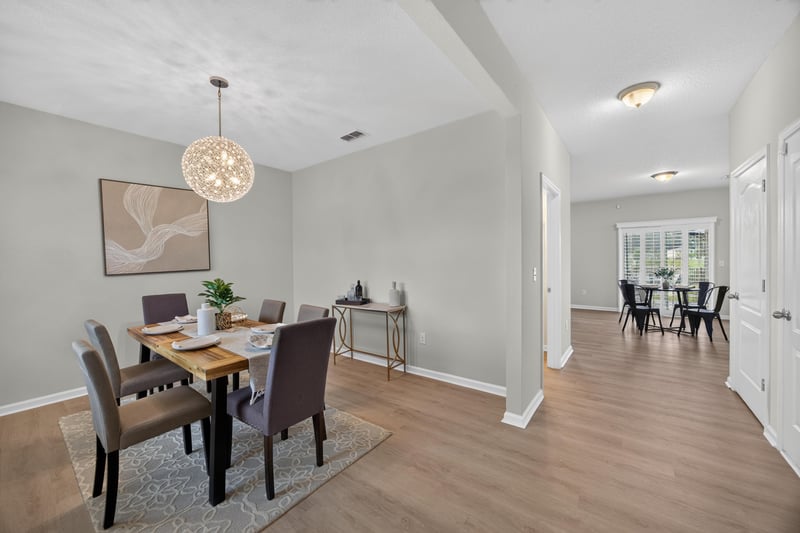 Entry hallway with dining table and wood floors at 6830 Hanford St, Jacksonville, FL 32219