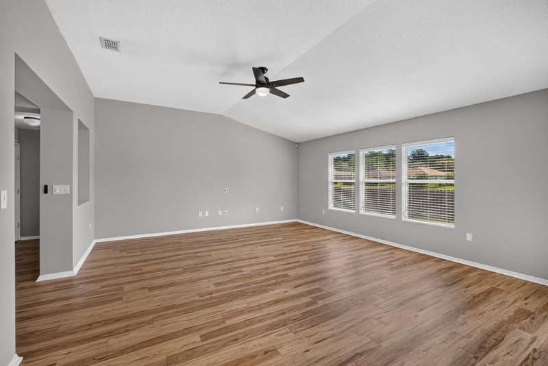 Empty living area with ceiling fan at 7545 Lirope St, Jacksonville, FL 32244