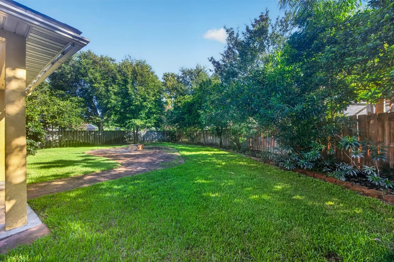 Backyard with mature trees and fence at 470 Sparrow Branch Cir, Jacksonville, FL 32259