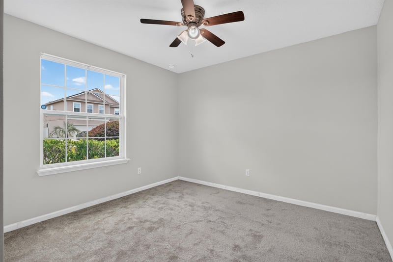 Bedroom with carpet flooring and window at 10066 Andean Fox Dr, Jacksonville, FL 32222