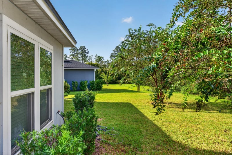 Screened porch with trees beyond at 95221 Siena Ct, Fernandina Beach, FL 32034