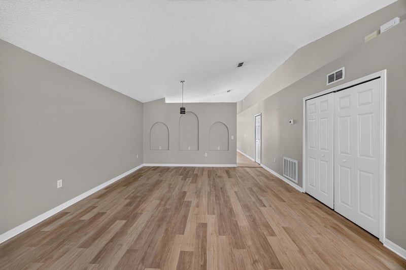 Living area with vaulted ceiling and double doors at 1845 Saga Ct, Middleburg, FL