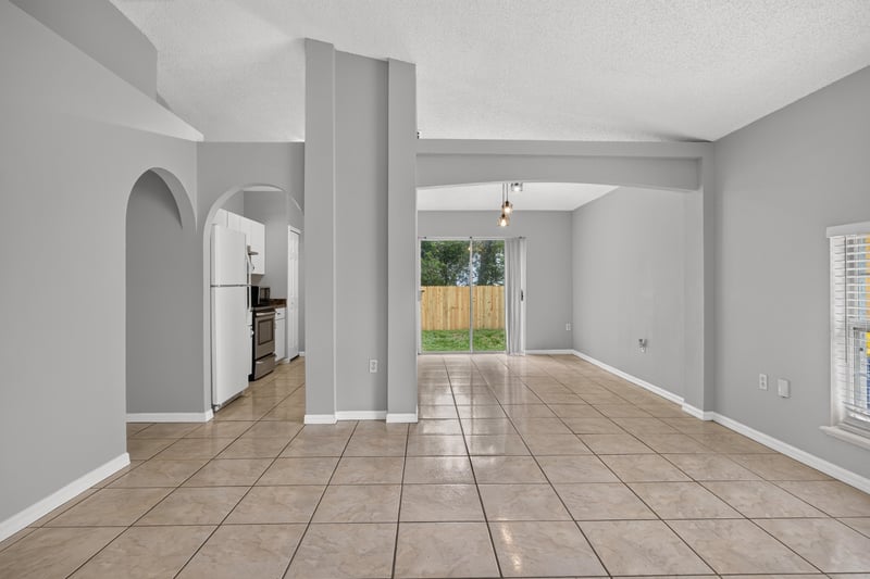 Living room with tile floor and view to sliding glass door at 7329 Lawn Tennis Ln, Jacksonville, FL
