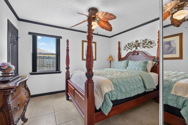 Bedroom with four-poster bed at 6931 Cane Grass Ln E, Jacksonville, FL 32244