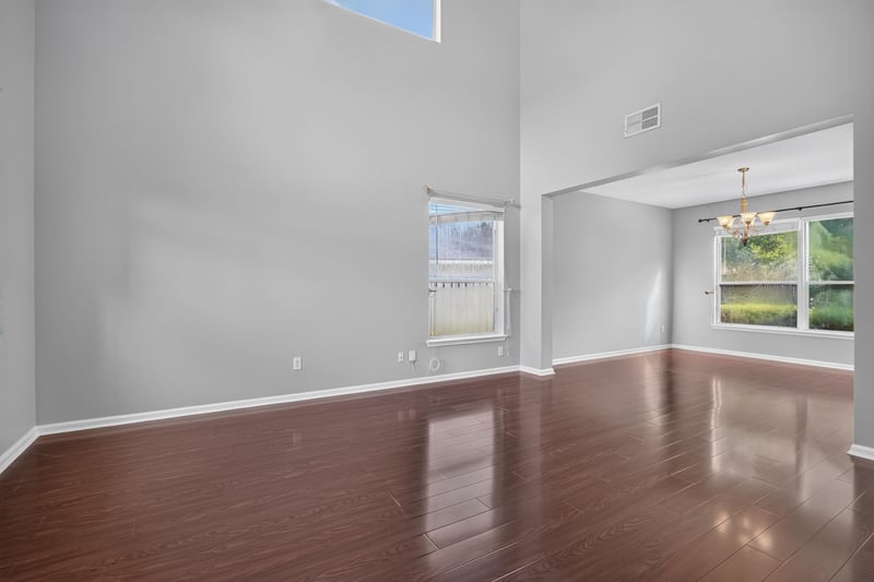 Living room with wood floors and large window at 470 Sparrow Branch Cir, Jacksonville, FL 32259