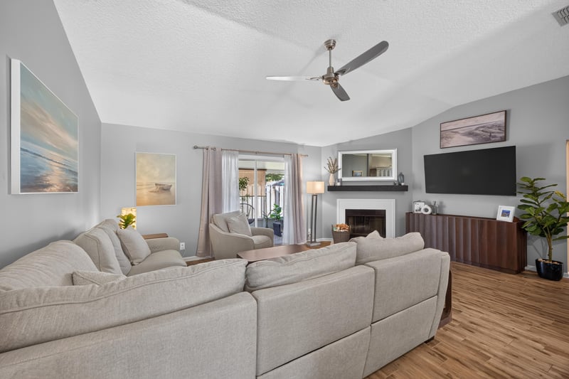 Living room with sofa and ceiling fan at 12825 Kelsey Island Dr, Jacksonville, FL 32224