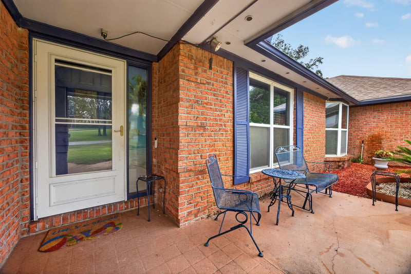 Enclosed porch with brick walls and seating area at 981 Marble Ridge Dr, Orange Park, FL 32065