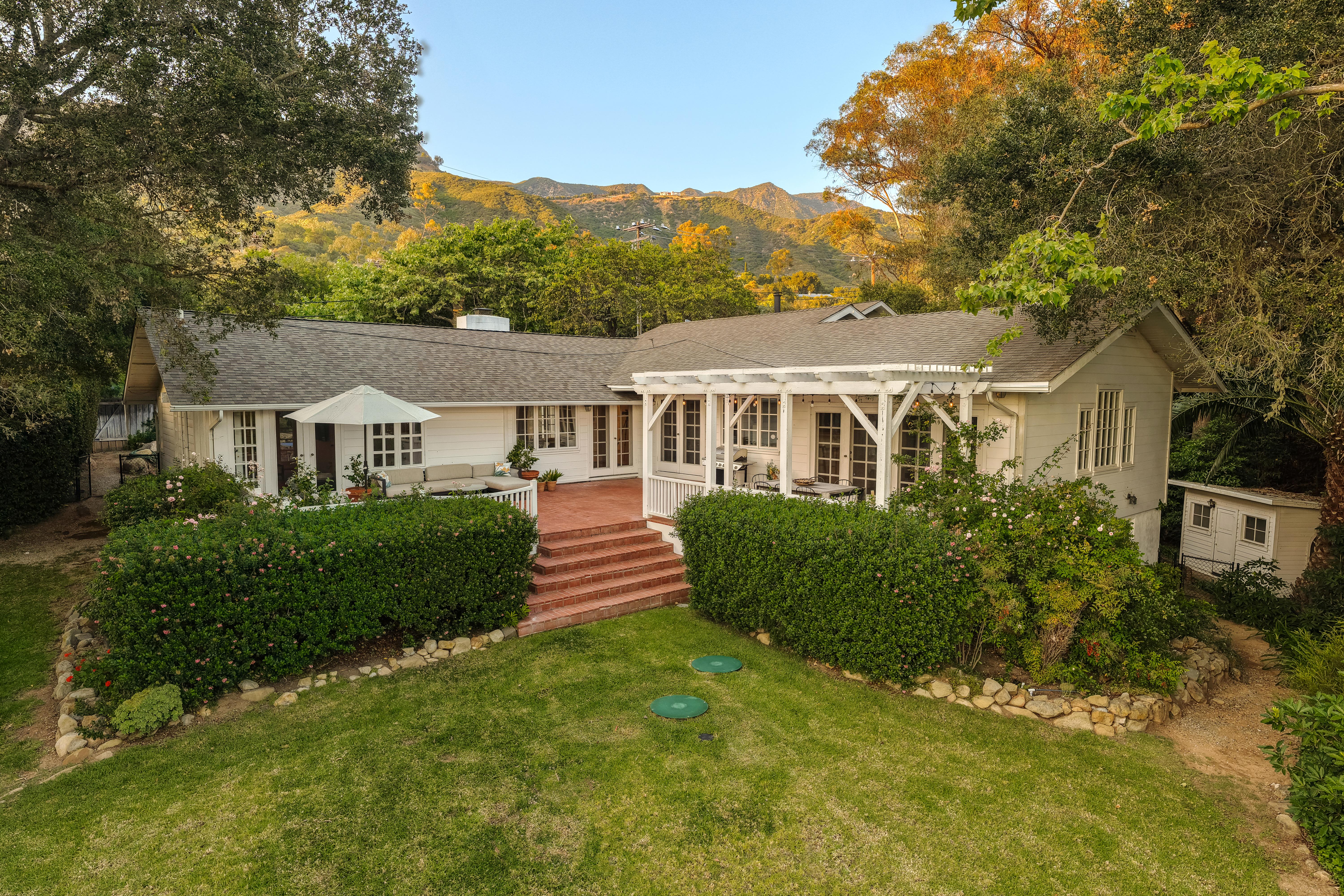 Exterior twilight photography of luxury residence at 2915 Hidden Valley Ln, Santa Barbara — warm evening light falls across the facade as the Santa Ynez Mountains recede into dusk in this professional real estate photography portfolio by VirTour Media. Our team captured still photography, aerial drone photography, and twilight photography from late afternoon through twilight.