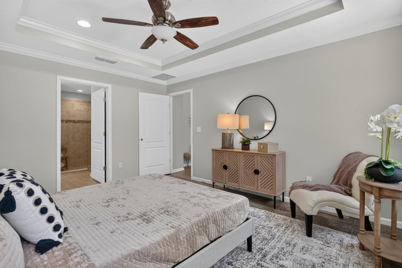 Bedroom with nightstand and patterned bedding at 10066 Andean Fox Dr, Jacksonville, FL 32222