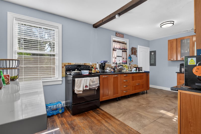 Kitchen with wood cabinets and tile floor at 5745 110th St, Jacksonville, FL 32244