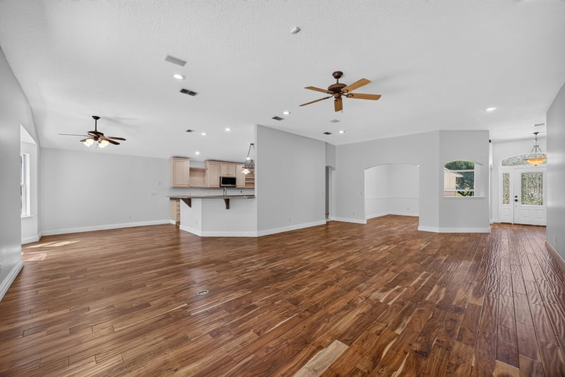 Open living and kitchen area with wood floors at 11675 Magnolia Estates Rd, Jacksonville, FL 32223