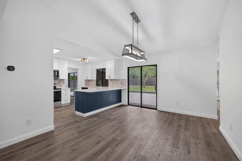 Kitchen with blue island and pendant lighting at 551 Deltona Blvd, St. Augustine, FL 32086