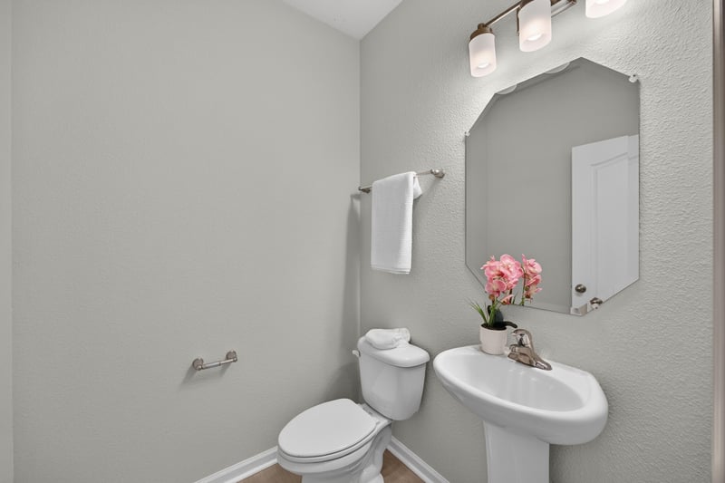 Half bath with pedestal sink and toilet at 6830 Hanford St, Jacksonville, FL 32219