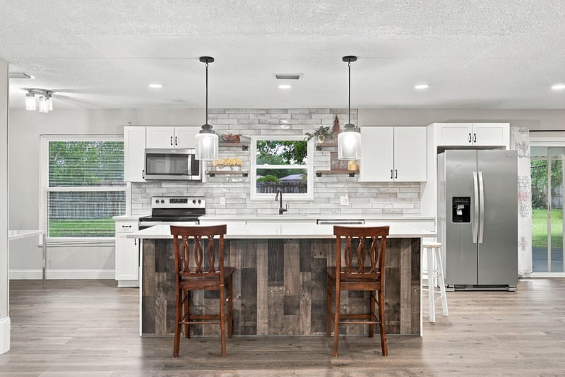 Kitchen with white cabinets and island seating at 357 Dillon Dr, Orange Park, FL