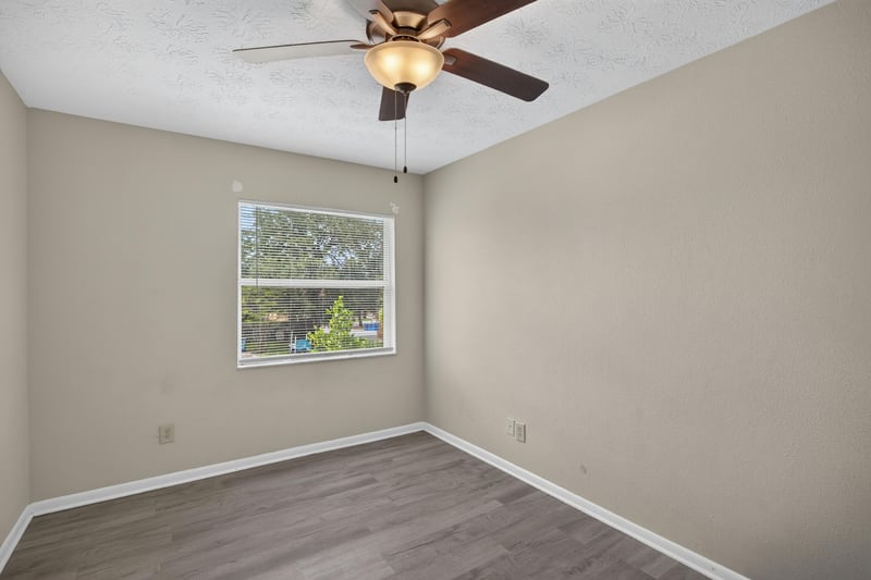 Bedroom with ceiling fan and corner window at 2658 Trollie Ln apt 1, Jacksonville, FL 32211