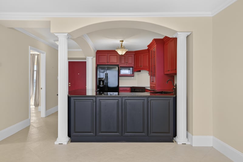 Kitchen opening to living area through columns at 1301 1st St S