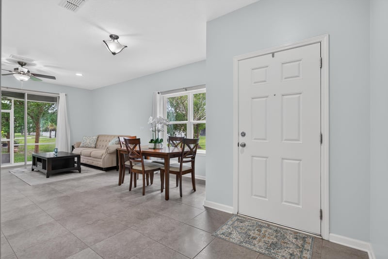 Living room with front door and dining table beyond at 2378 Caney Oaks Dr, Jacksonville, FL