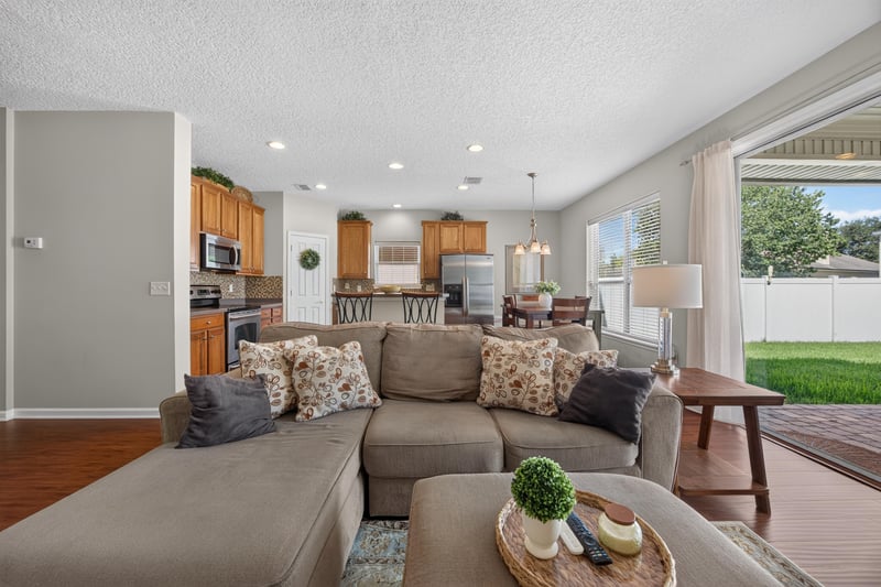 Family room with sectional sofa and sliding glass doors at 3660 Middlebrook Dr, Orange Park, FL 32065