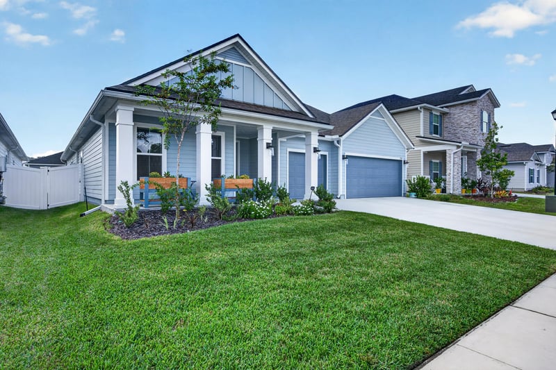 Front exterior with covered porch and landscaped yard at 2354 Jennings Farm Dr, Middleburg, FL 32068