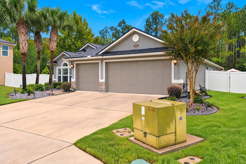 Front exterior with driveway and landscaping at 10923 Black Diamond Ct, Jacksonville, FL