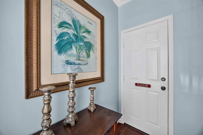 Hallway with framed art and a white entry door at 115 Cordova St, St. Augustine, FL