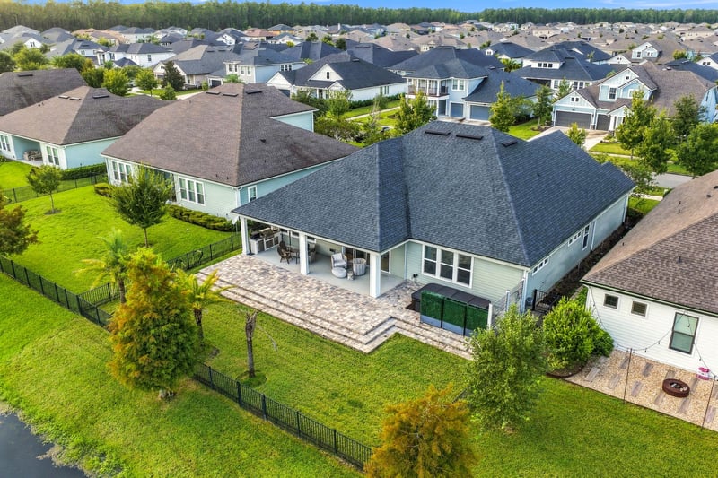 Aerial view of the rear roofline and pond at 3921 Spyglass Hill Ln