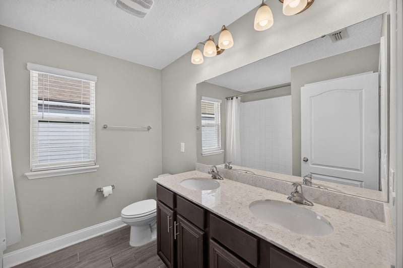 Bathroom vanity mirror and toilet at 331 Millerstone Dr, St. Augustine, FL 32092