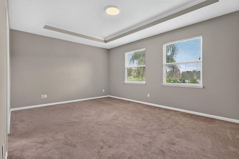 Bedroom with carpet and tray ceiling at 13685 Goodson Pl, Jacksonville, FL 32226