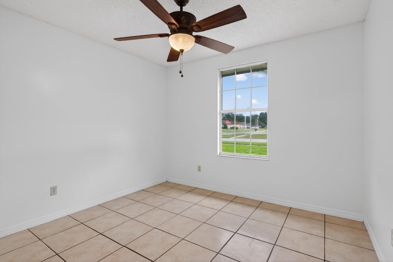 Bedroom with tile floor and window at 2164 Orangewood St, Middleburg, FL 32068