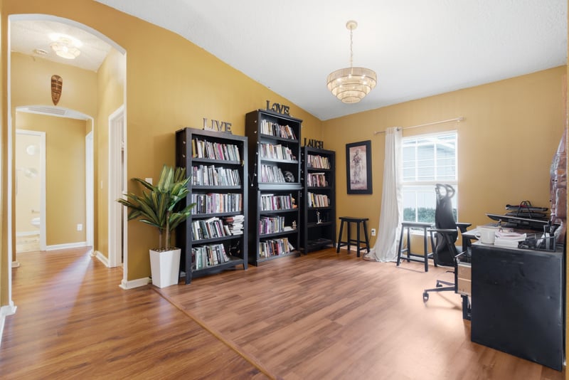Den with built-in bookshelves and desk at 7392 Timber Falls Ct