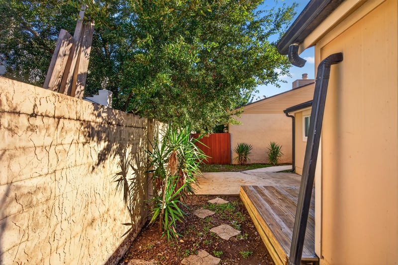 Backyard with wood fence and mature tree at 8177 Virgo St, Jacksonville, FL 32216