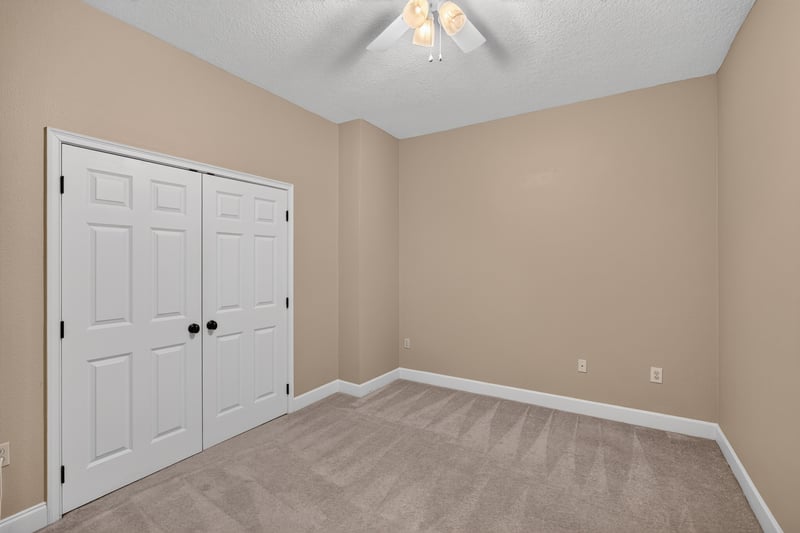 Bedroom closet with double doors and ceiling fan at 1478 Riverplace Blvd 1904, Jacksonville, FL 32207