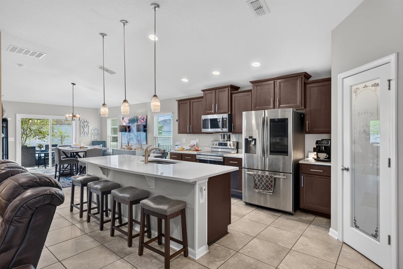 Kitchen island with pendant lighting and bar seating at 589 Seville Pkwy, St. Augustine, FL
