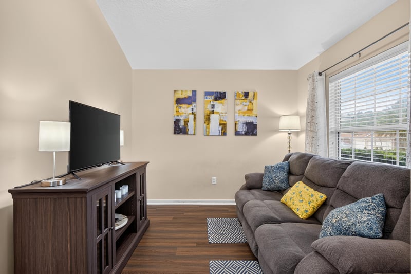 Living room with sofa and area rug at 3112 Silverado Cir, Green Cove Springs, FL 32043