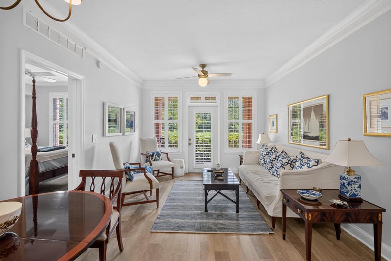 Living room with sofa and plantation shutters at 10435 Mid Town Pkwy unit 135, Jacksonville, FL 32246
