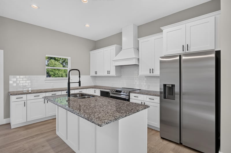 Kitchen island with granite counters and stainless appliances at 175 Alava Ct