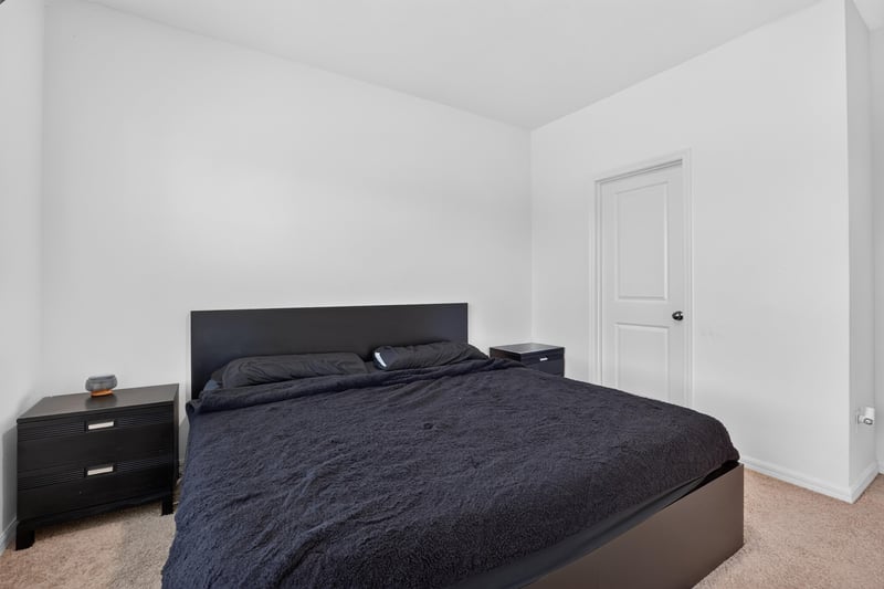 Primary bedroom with dark bed frame and nightstands at 339 Anthony Dr, Jacksonville, FL